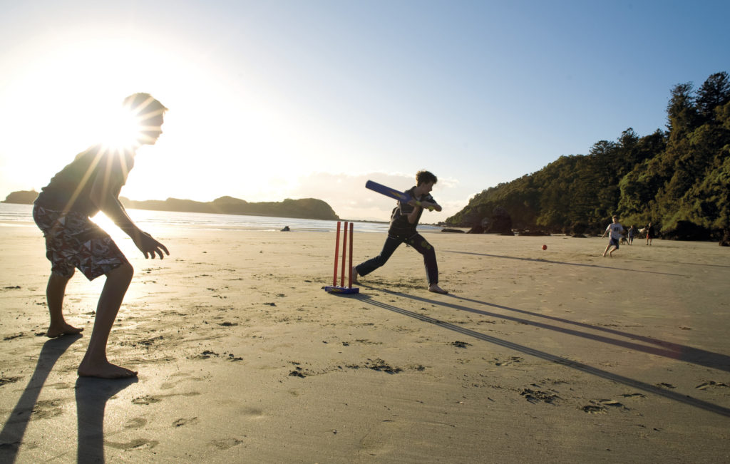 Playing cricket on the beach